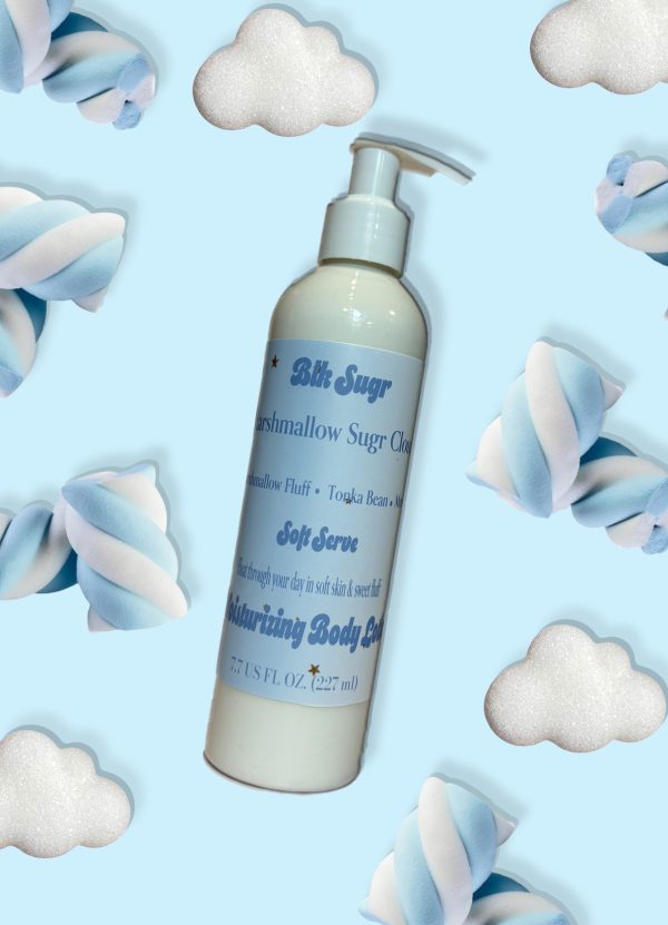 A bottle of Blk Sugr Marshmallow Sugr Cloud Soft Serve Lotion on a baby blue background, surrounded by soft marshmallows and fluffy clouds.