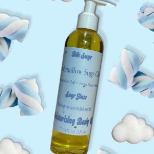A bottle of Blk Sugr “Marshmallow Sugr Cloud” Sugr Glaze body oil on a sky blue background, surrounded by blue and white marshmallow twists and fluffy white cloud illustrations. The label lists notes of marshmallow fluff, tonka bean, and musk.