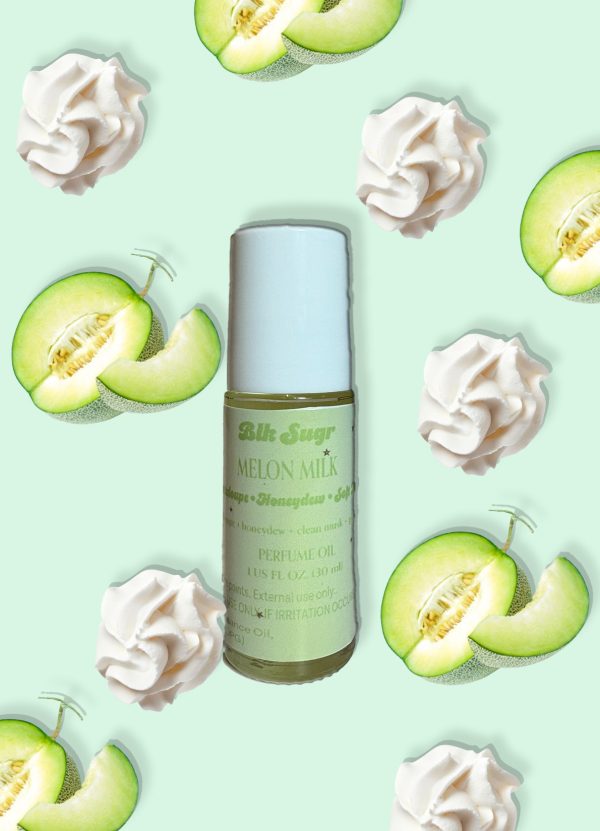 A bottle of Blk Sugr “Melon Milk” perfume oil placed on a mint green background, surrounded by sliced honeydew melon and soft whipped cream swirls. The label highlights notes of cantaloupe, honeydew, and clean musk.