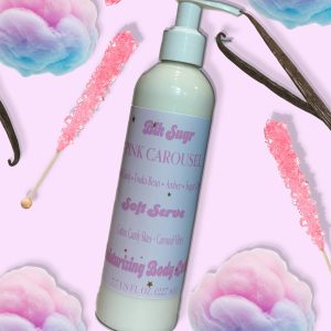 A bottle of Blk Sugr Pink Carousel Soft Serve Lotion on a pastel pink background with cotton candy, pink rock candy sticks, vanilla bean pods, and sugar crystals.